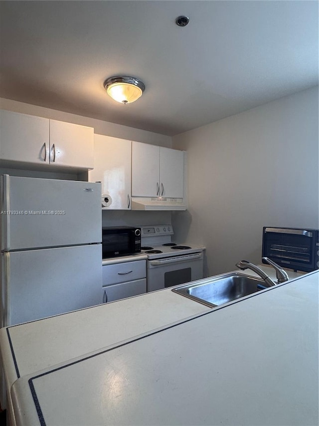 361 Collins Ave Unit A2, Miami Beach, FL 33139 - kitchen featuring a sink, white appliances, under cabinet range hood, white cabinetry, and light countertops