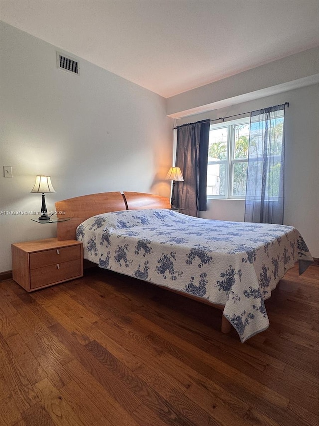 361 Collins Ave Unit A2, Miami Beach, FL 33139 - bedroom with visible vents and wood finished floors