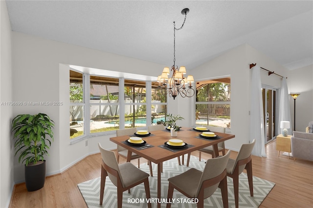 15941 Cobblestone Ct, Davie, FL 33331 - dining area with a chandelier, light wood-type flooring, and lofted ceiling