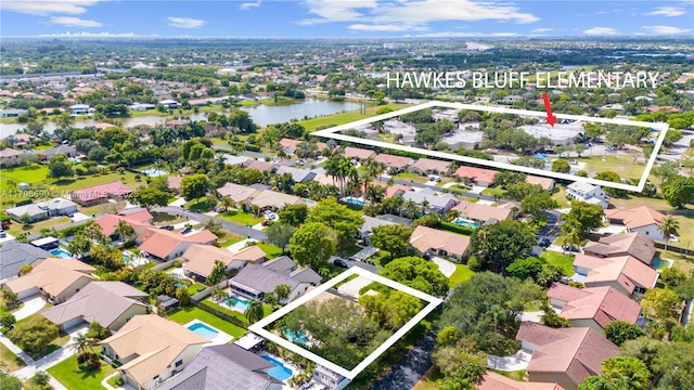 bird's eye view featuring a water view and a residential view