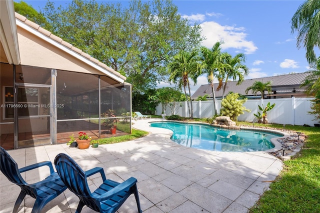 view of pool with a patio area, a sunroom, a fenced in pool, and a fenced backyard