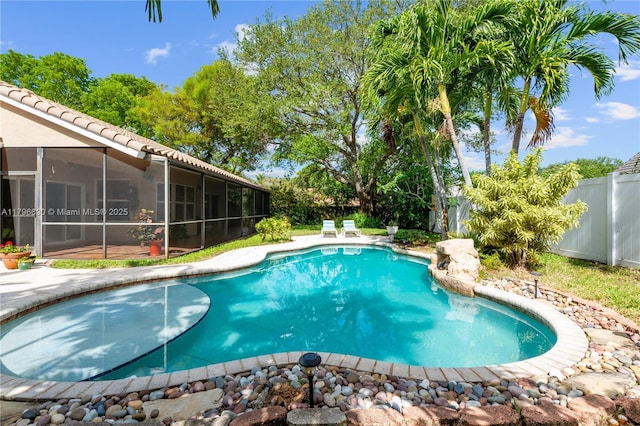 view of pool with a sunroom, a fenced in pool, and a fenced backyard