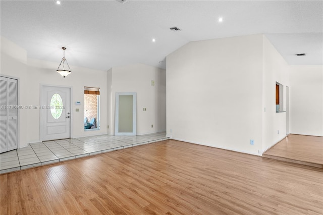 entrance foyer featuring vaulted ceiling, visible vents, light wood-style flooring, and recessed lighting