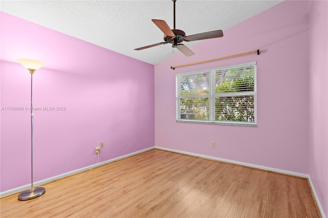 15941 Cobblestone Ct, Davie, FL 33331 - empty room with wood finished floors, vaulted ceiling, a textured ceiling, a ceiling fan, and baseboards