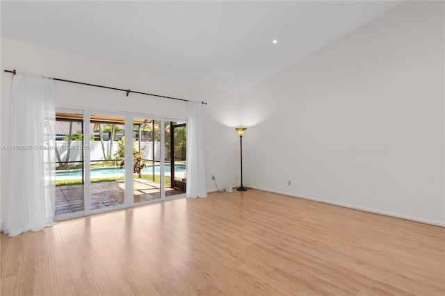 unfurnished room with light wood finished floors and baseboards