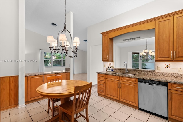 kitchen with brown cabinets, a sink, a notable chandelier, visible vents, and dishwasher