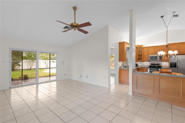 interior space featuring ceiling fan with notable chandelier, brown cabinets, high vaulted ceiling, open floor plan, and appliances with stainless steel finishes
