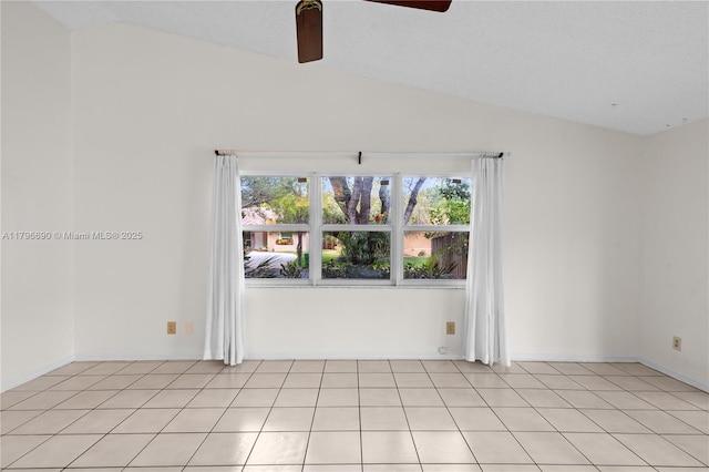 unfurnished room featuring lofted ceiling, light tile patterned flooring, and a ceiling fan