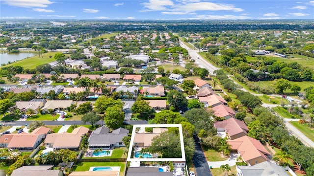 drone / aerial view with a water view and a residential view