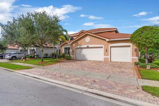 4528 SW 183rd Ave, Miramar, FL 33029 - mediterranean / spanish house with a tile roof, stucco siding, a garage, and decorative driveway