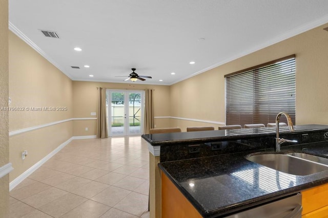 4528 SW 183rd Ave, Miramar, FL 33029 - kitchen with light tile patterned floors, french doors, a sink, baseboards, and ornamental molding