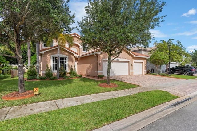 4528 SW 183rd Ave, Miramar, FL 33029 - mediterranean / spanish home with an attached garage, stucco siding, fence, a front lawn, and decorative driveway