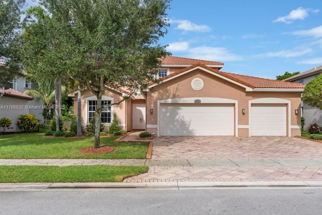 4528 SW 183rd Ave, Miramar, FL 33029 - view of front of home featuring an attached garage, a tile roof, stucco siding, a front lawn, and decorative driveway