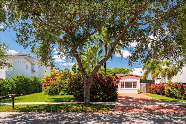310 Woodcrest Rd, Key Biscayne, FL 33149 - view of front of home with a front lawn and driveway