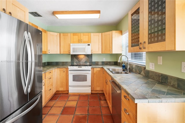 310 Woodcrest Rd, Key Biscayne, FL 33149 - kitchen with a sink, stainless steel appliances, tasteful backsplash, visible vents, and light brown cabinets