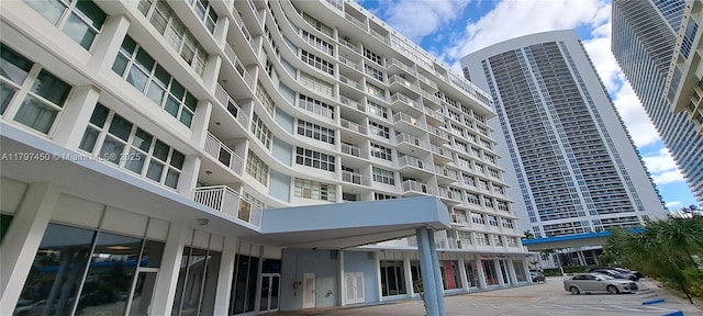 view of apartment building / complex with uncovered parking