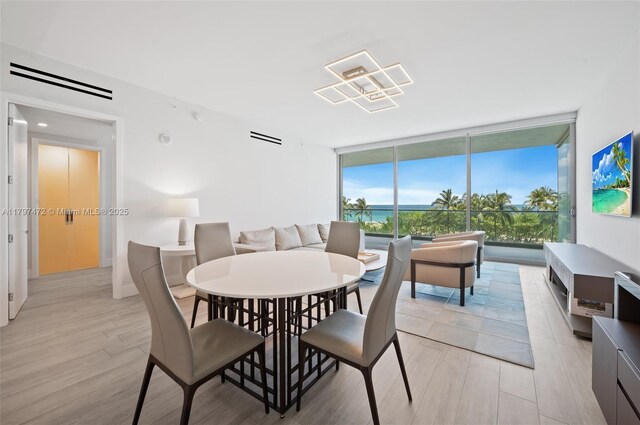 10201 Collins Ave Unit 303, Bal Harbour, FL 33154 - dining space featuring floor to ceiling windows and light wood-type flooring