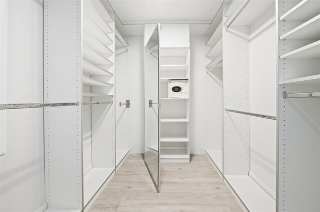 10201 Collins Ave Unit 303, Bal Harbour, FL 33154 - walk in closet featuring light wood finished floors