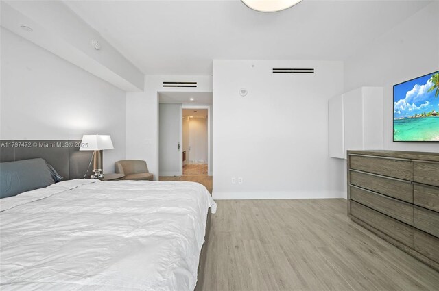 10201 Collins Ave Unit 303, Bal Harbour, FL 33154 - bedroom featuring wood finished floors and baseboards