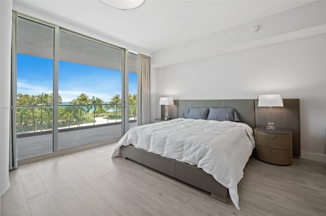10201 Collins Ave Unit 303, Bal Harbour, FL 33154 - bedroom featuring floor to ceiling windows, access to exterior, and wood finished floors