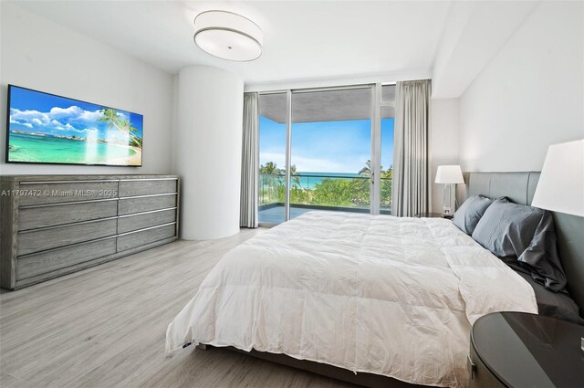 10201 Collins Ave Unit 303, Bal Harbour, FL 33154 - bedroom featuring floor to ceiling windows, access to outside, wood finished floors, and a water view