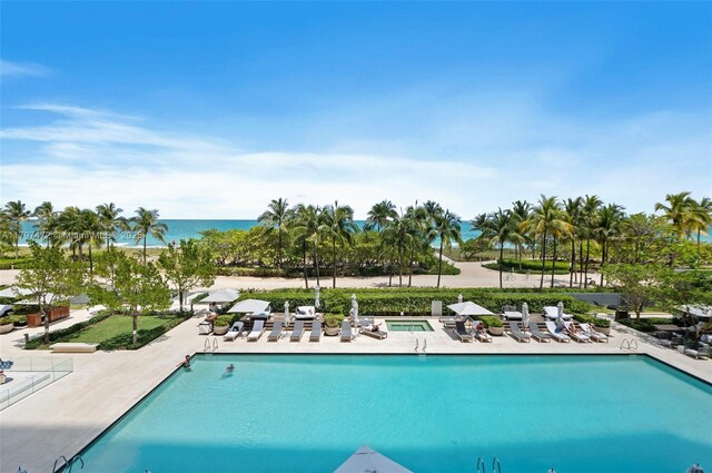 10201 Collins Ave Unit 303, Bal Harbour, FL 33154 - community pool featuring a patio, a water view, and a hot tub