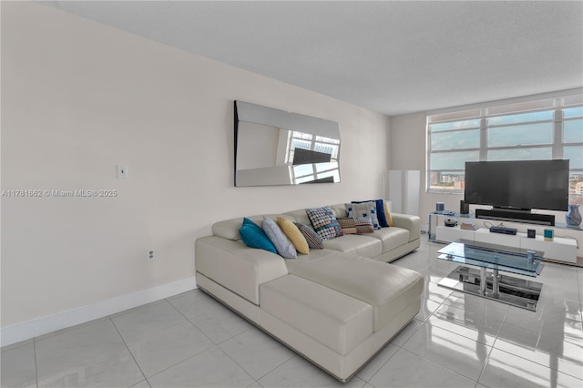 living area featuring a wealth of natural light and baseboards