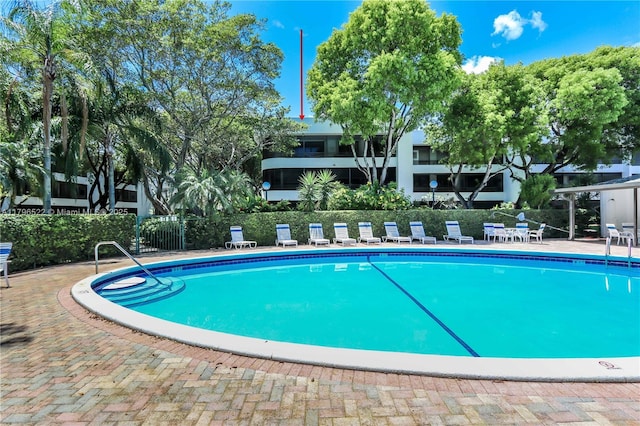 pool featuring fence and a patio