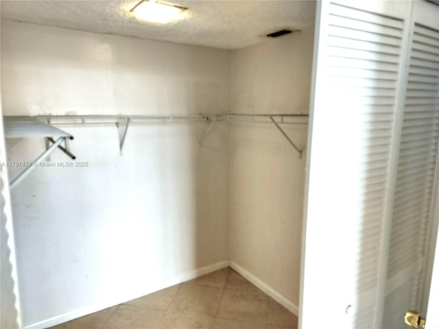 3660 NE 166th St Unit 302, North Miami Beach, FL 33160 - walk in closet featuring light tile patterned floors