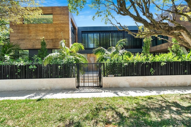 3101 Jefferson St, Miami, FL 33133 - contemporary home featuring a fenced front yard, stucco siding, and a gate