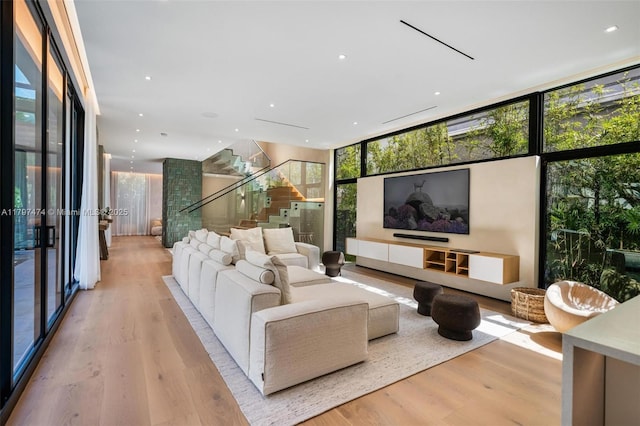 3101 Jefferson St, Miami, FL 33133 - living room with light wood-type flooring, stairway, and expansive windows