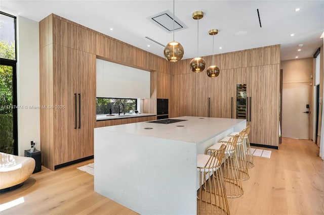 3101 Jefferson St, Miami, FL 33133 - kitchen with light wood finished floors, light countertops, modern cabinets, and a kitchen island