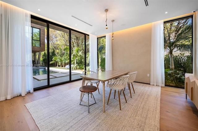 3101 Jefferson St, Miami, FL 33133 - dining room featuring a wall of windows and light wood-style flooring