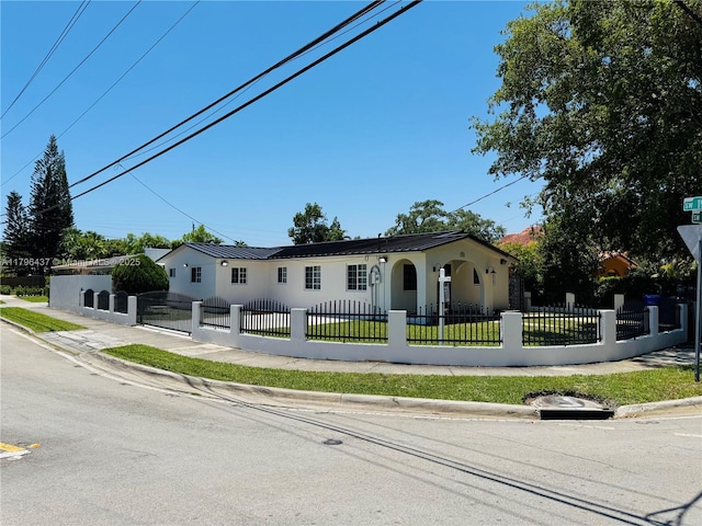 1900 SW 24th St, Miami, FL 33145 - view of front facade with stucco siding, metal roof, and a fenced front yard