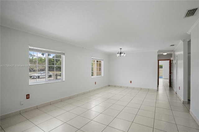 unfurnished room with baseboards, a notable chandelier, visible vents, and light tile patterned flooring