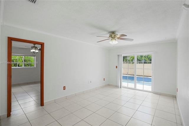 spare room featuring ceiling fan, ornamental molding, light tile patterned floors, and plenty of natural light