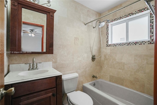 full bath featuring toilet, shower / tub combination, tile walls, ceiling fan, and vanity