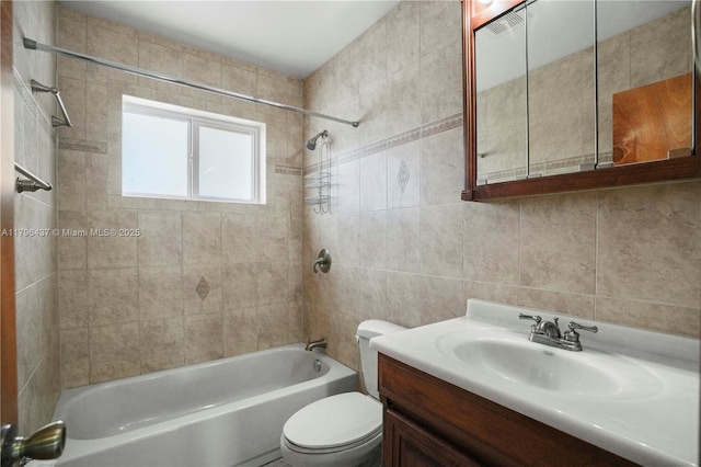 full bath featuring tile walls, toilet,  shower combination, and vanity
