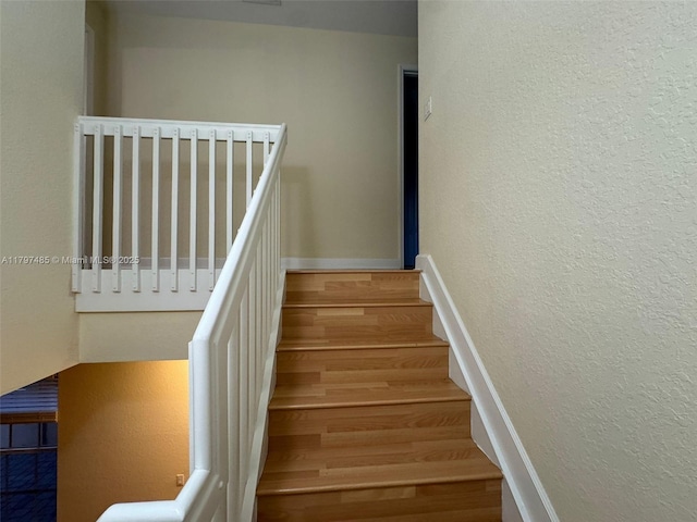 8706 Blaze Ct, Davie, FL 33328 - stairway with wood finished floors, a textured wall, and baseboards