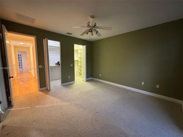 8706 Blaze Ct, Davie, FL 33328 - unfurnished bedroom with light carpet, baseboards, ceiling fan, and a spacious closet