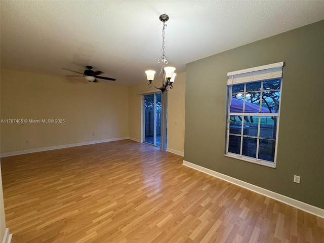 8706 Blaze Ct, Davie, FL 33328 - spare room featuring light wood-style floors, a chandelier, baseboards, ceiling fan, and a textured ceiling
