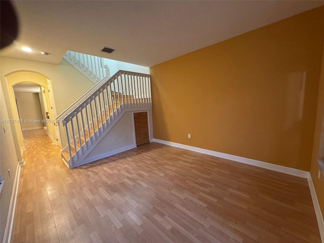 8706 Blaze Ct, Davie, FL 33328 - unfurnished living room with arched walkways, wood finished floors, baseboards, and recessed lighting