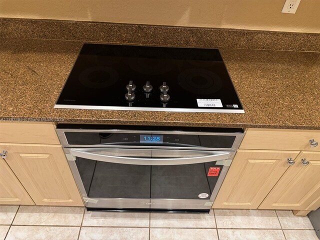 8706 Blaze Ct, Davie, FL 33328 - detailed view of stainless steel oven, black electric cooktop, and dark countertops