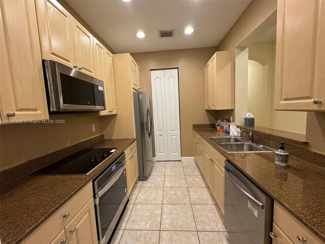 8706 Blaze Ct, Davie, FL 33328 - kitchen with appliances with stainless steel finishes, a sink, light tile patterned floors, dark stone counters, and recessed lighting