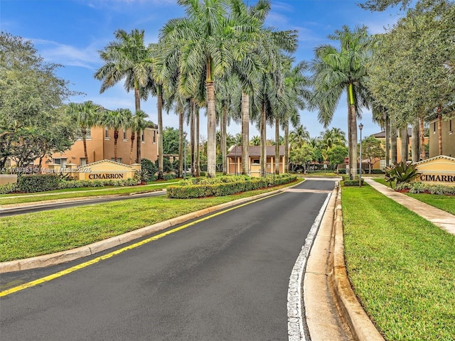 8706 Blaze Ct, Davie, FL 33328 - view of asphalt road featuring curbs, sidewalks, and traffic signs