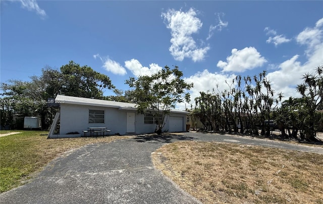 660 SW 14th Pl, Deerfield Beach, FL 33441 - ranch-style home with a front lawn, driveway, stucco siding, and a garage