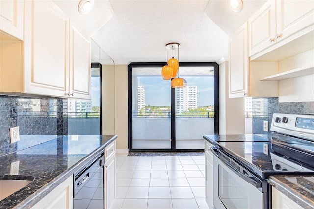 1500 N Ocean Blvd Unit 502, Pompano Beach, FL 33062 - kitchen with stainless steel range with electric cooktop, white dishwasher, light tile patterned flooring, and dark stone countertops