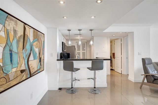 770 Claughton Island Dr Unit 1114, Miami, FL 33131 - kitchen featuring appliances with stainless steel finishes, dark countertops, a kitchen bar, recessed lighting, and a peninsula