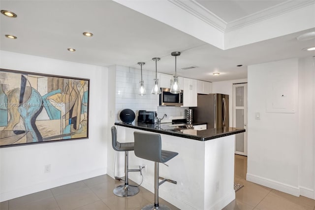 770 Claughton Island Dr Unit 1114, Miami, FL 33131 - kitchen with stainless steel appliances, a peninsula, white cabinets, ornamental molding, and backsplash