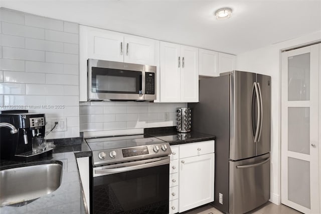 770 Claughton Island Dr Unit 1114, Miami, FL 33131 - kitchen featuring stainless steel appliances, white cabinets, and tasteful backsplash